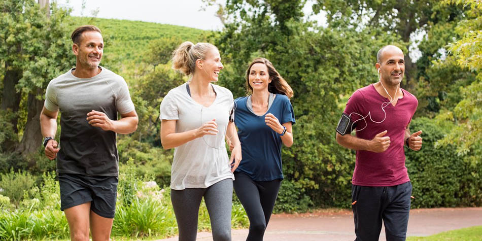 A group of four runners running outside.