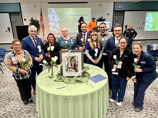 Riverside Community Hospital leadership who play a vital role in the donation process hold a message they wrote on a rose vial that will be included in the Rose Parade float.